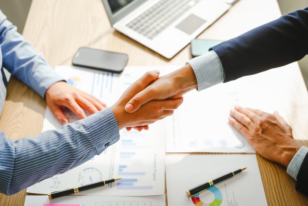 Businessman conducts financial discussions, sealing deals with handshakes. Expert in accounts, loans, mortgages, interest rates, credit scores, savings, checking, stocks, bonds, mutual funds